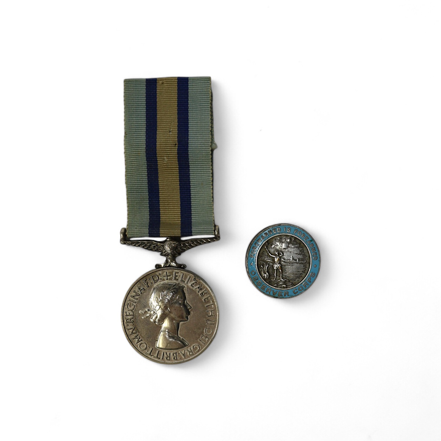 An ERII (B) Royal Observer Corps medal to Observer W.Cook with a lapel badge. Condition - fair.